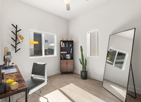 the living room of a studio apartment with a mirror and a desk at SECOND AVE COMMONS | BRAND-NEW, Mesa