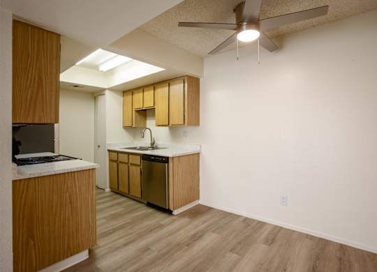A kitchen with wooden cabinets and a white counter.