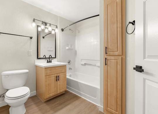 A white toilet sits next to a sink in a bathroom.