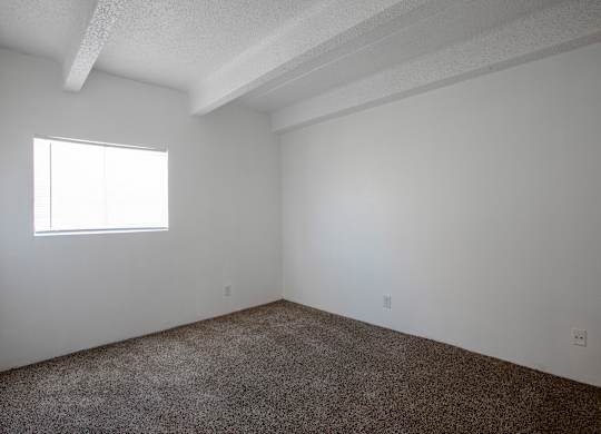 Bedroom with carpet at Los Altos Towers Apartments in Albuquerque NM