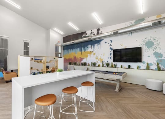 a living room with a white bar and stools at SECOND AVE COMMONS | BRAND-NEW, Mesa, Arizona