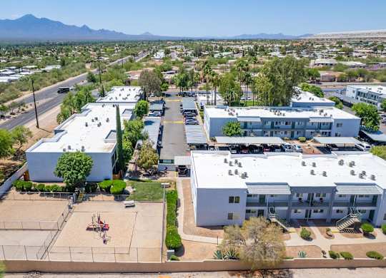 A large white building with a parking lot in front of it.