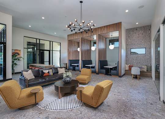 A modern living room with a sofa, chairs, and a coffee table.