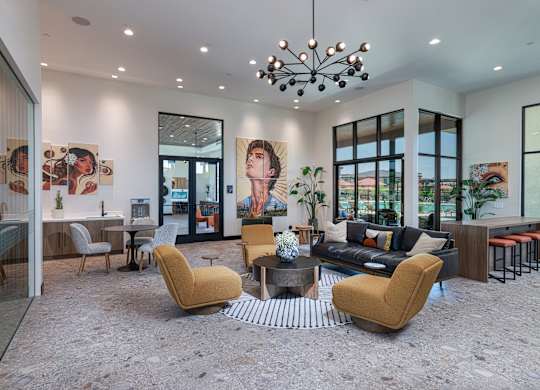 A modern living room with a yellow chair in the center.