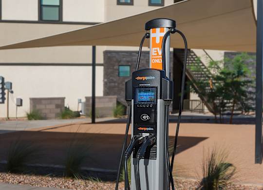 An electric vehicle charging station is installed in a parking lot.