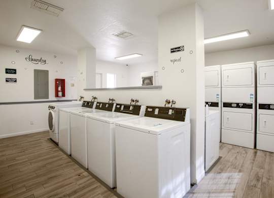 A laundry room with washers and dryers.