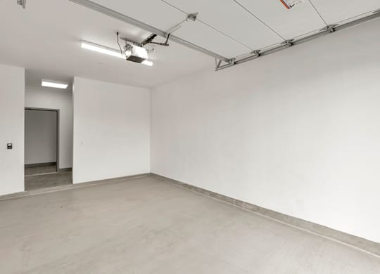 A large empty room with a concrete floor and white walls.