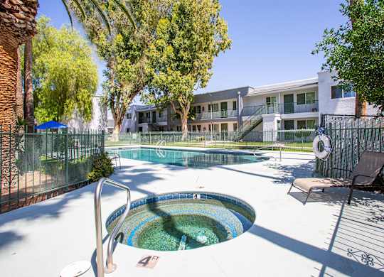 A pool with a hot tub in the middle of it.