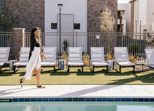 Pool with lounge seating at The Aster at Mountain Vista in Mesa Arizona