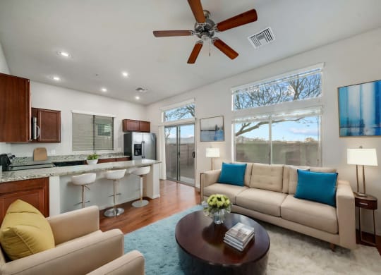Spacious Living Room and Kitchen with Breakfast Bar at Avilla Preserve Apartment Homes in Tucson Arizona