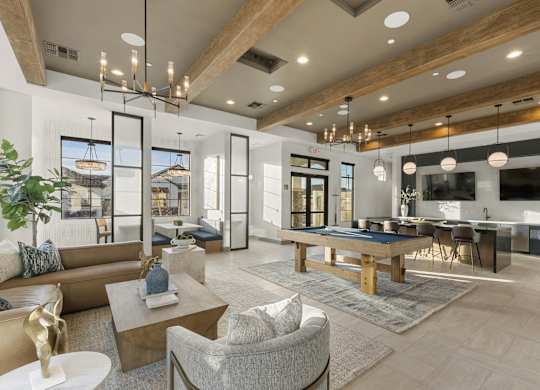A modern living room with a large couch, a coffee table, and a TV.