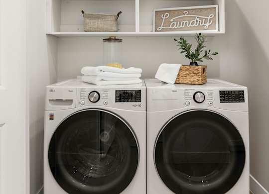 Two washing machines are in a laundry room.