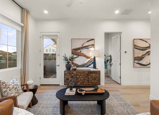 A living room with a fireplace and a painting on the wall.