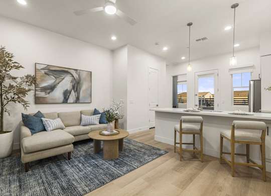 A living room with a couch, a table, and a painting on the wall.