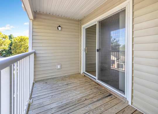 A deck with a sliding glass door leading to a balcony. at Ardenwood Apartments, North Haven, CT