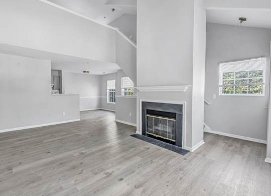A spacious living room with a fireplace and hardwood floors. at Ardenwood Apartments, Connecticut, 06473
