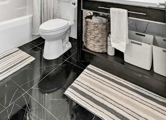 a bathroom with a toilet and a sink and a mirror at The Meriden, Connecticut, 06450