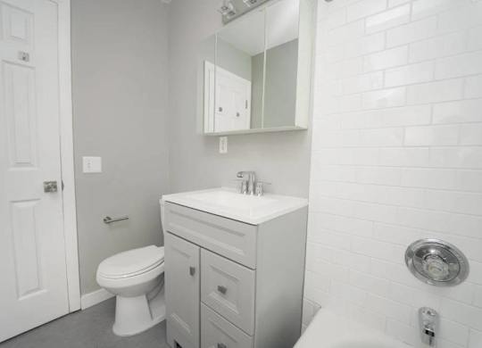 a white bathroom with a sink and a toilet at Encore 99, Connecticut, 06512
