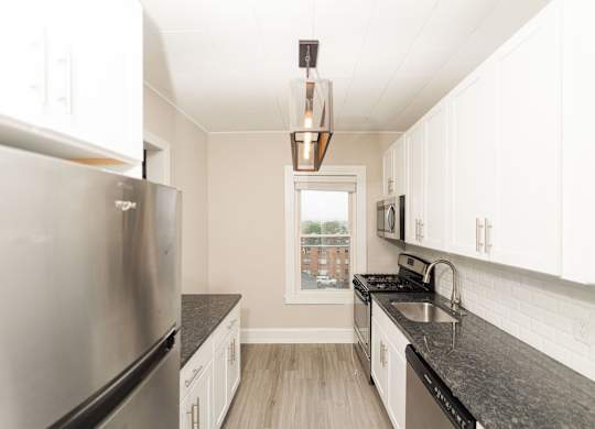 a kitchen with granite counter tops and stainless steel appliances at The Packard, West Hartford, Connecticut