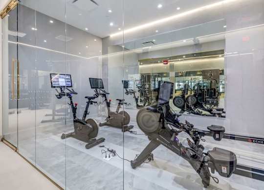a gym with cardio equipment and glass walls at Up House, Connecticut
