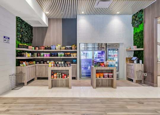 the lobby of a store with a refrigerator and shelves of food at Up House, Connecticut