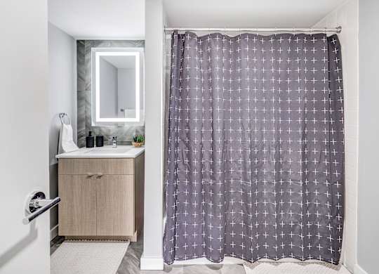 a bathroom with a shower curtain and a sink at Up House, Farmington, Connecticut