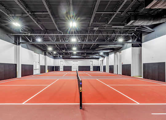 a tennis court in a building with lights on the ceiling at Up House, Farmington, Connecticut