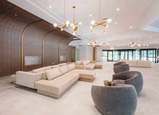 a lobby with couches and chairs and chandeliers at Up House, Farmington, CT, 06032