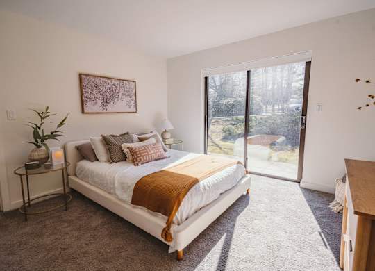 a bedroom with a bed and a sliding glass door at Up House, Farmington