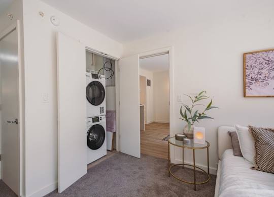 a living room with a washing machine and a dryer in it at Up House, Farmington, 06032