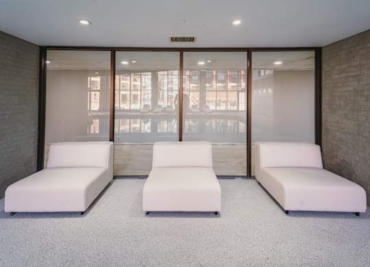 a room filled with white couches and a window at Up House, Farmington