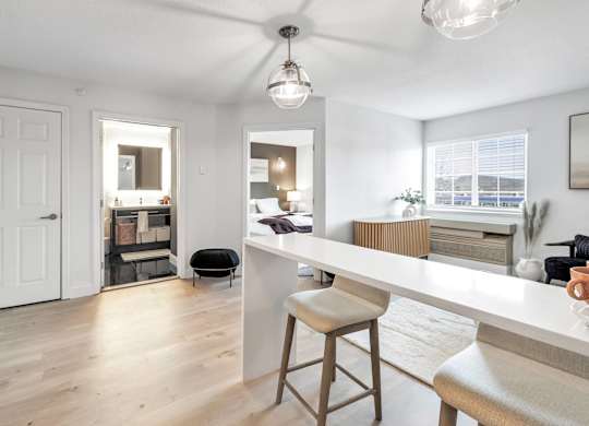 an open kitchen and living room with a white counter top at The Meriden, Meriden