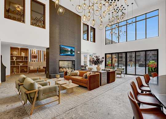 A modern living room with a fireplace and a long dining table.