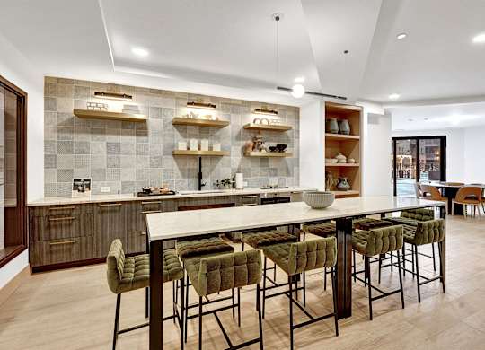 A modern kitchen with a dining table and chairs.