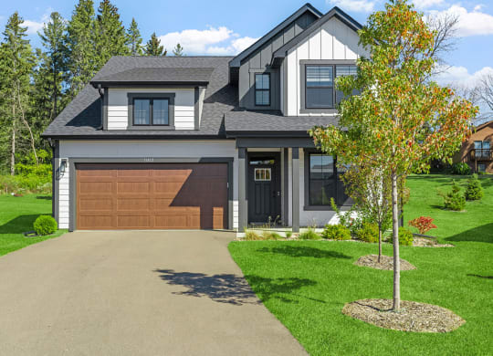 a house with a brown garage door and a driveway
