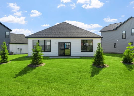 a white house with a yard in front of it