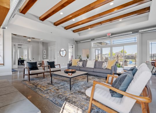 a living room with couches and chairs and a rug