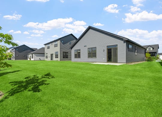 a group of houses in a grassy yard
