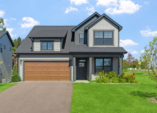 a house with a garage door in front of it