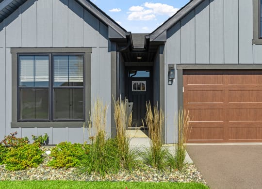the front of a house with a garage door and