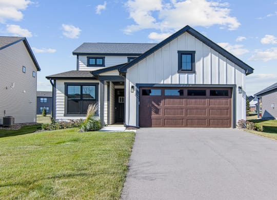 a house with a brown garage door and a driveway