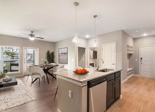 A modern kitchen with a dining table and chairs.
