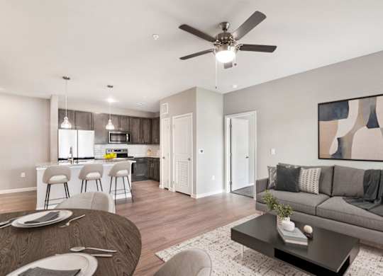 A modern living room with a grey couch and a wooden coffee table.