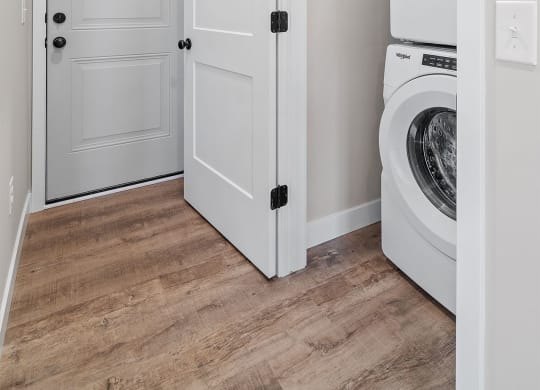 a laundry room with white doors and a washer and dryer