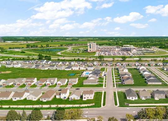 A suburban neighborhood with a large building in the distance.