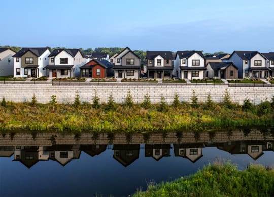 a row of houses reflected in a body of water