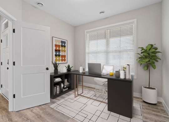 a home office with a desk and a door to a closet