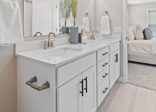 a white bathroom with a sink and a mirror