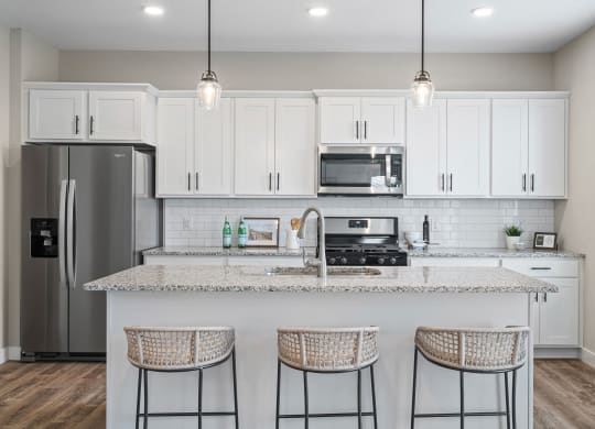 a kitchen with white cabinets and a counter top