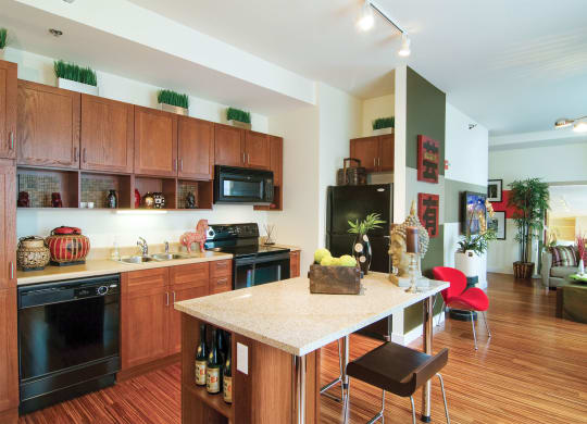 a kitchen and living room with a marble counter top